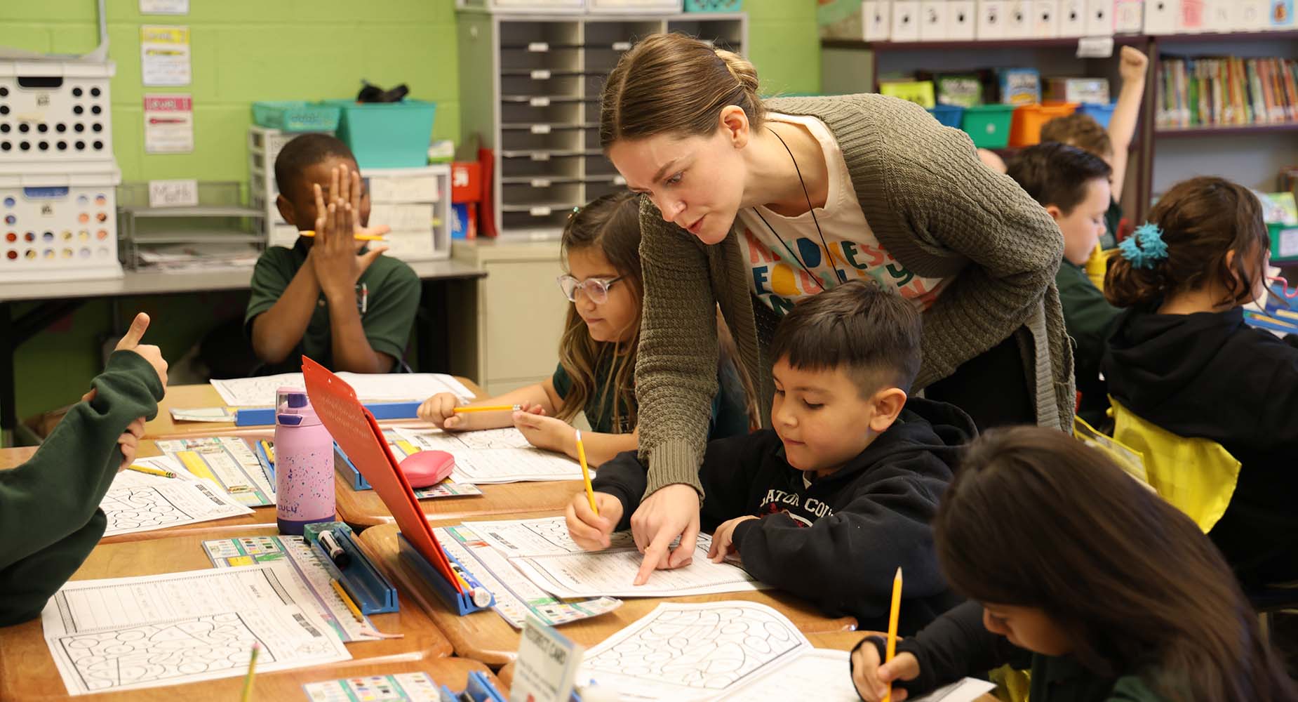 Teacher helping student