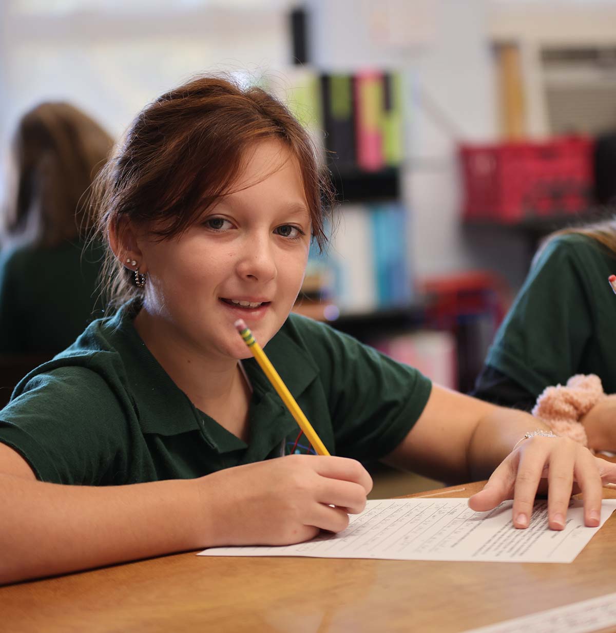 Student drawing in a classroom.